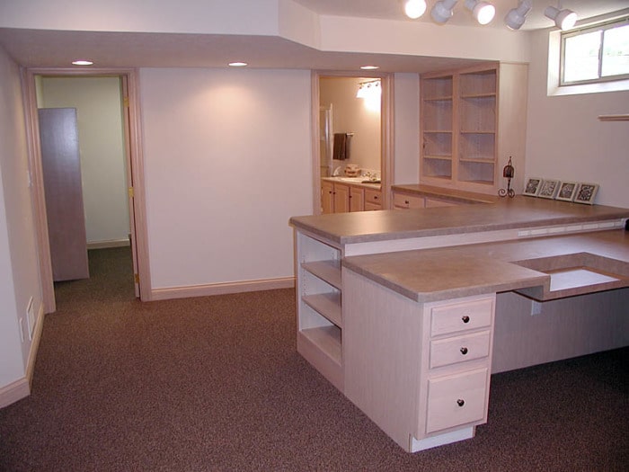 Sewing studio with built-in shelving, counters, and drawers.