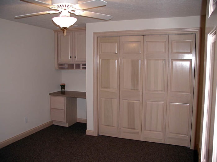 Finished basement bedroom with closet and built-in desk.counters, and drawers.