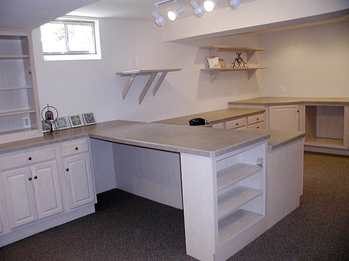 Sewing studio with built-in shelving, counters, and drawers.