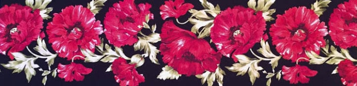 A fabric border print of florals on a black background.