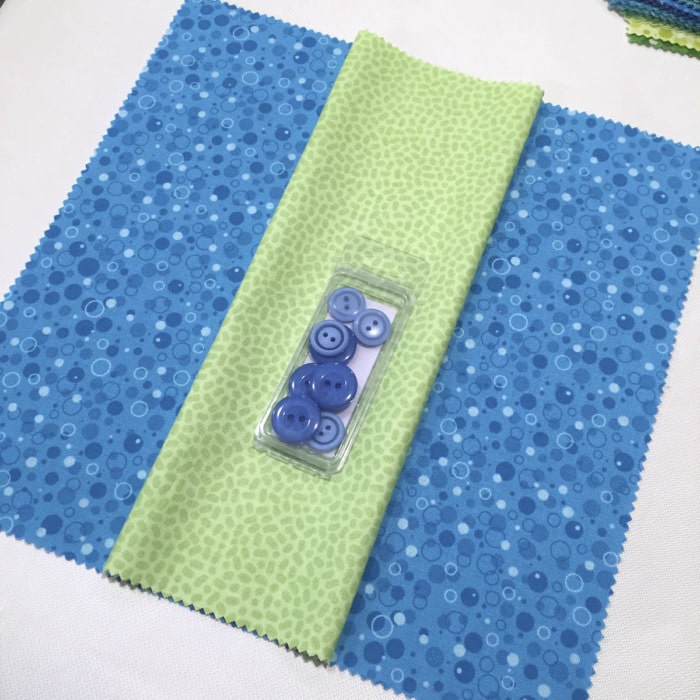 Auditioning buttons and fabric for a sewing project