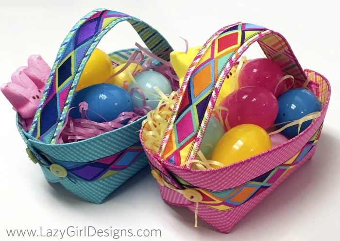 Picture of two Easter Baskets filled with grass, candy, and plastic eggs.