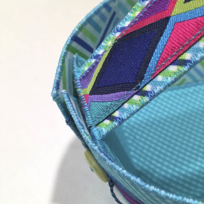 Close up picture of zigzag stitching showing where a handle is attached to a Button Boats organizer to make it into an Easter Basket.