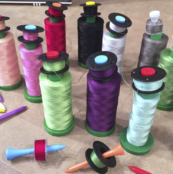 Use golf tees to organize bobbins