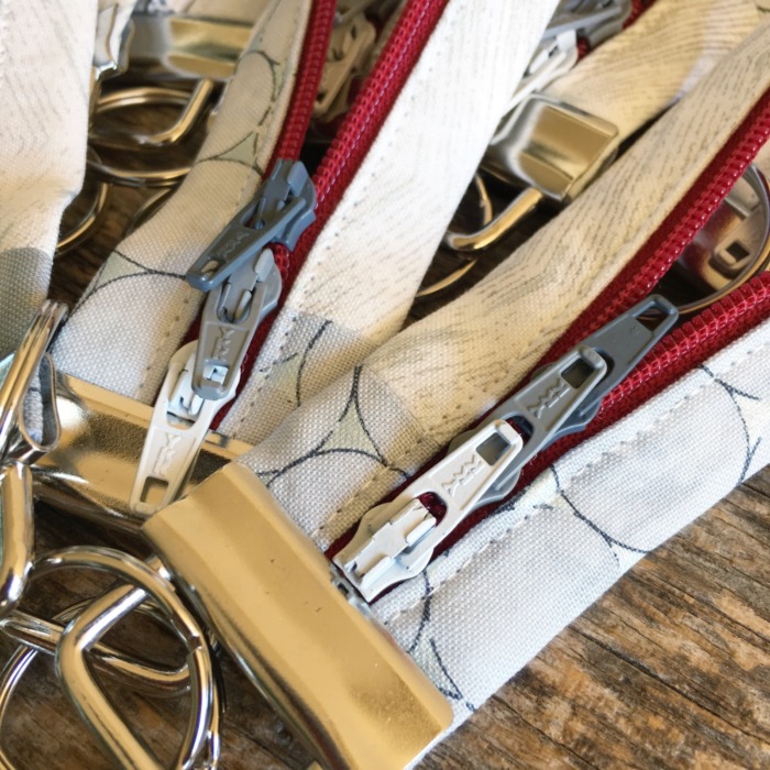 Close up of key fobs with multi-colored zipper pulls.