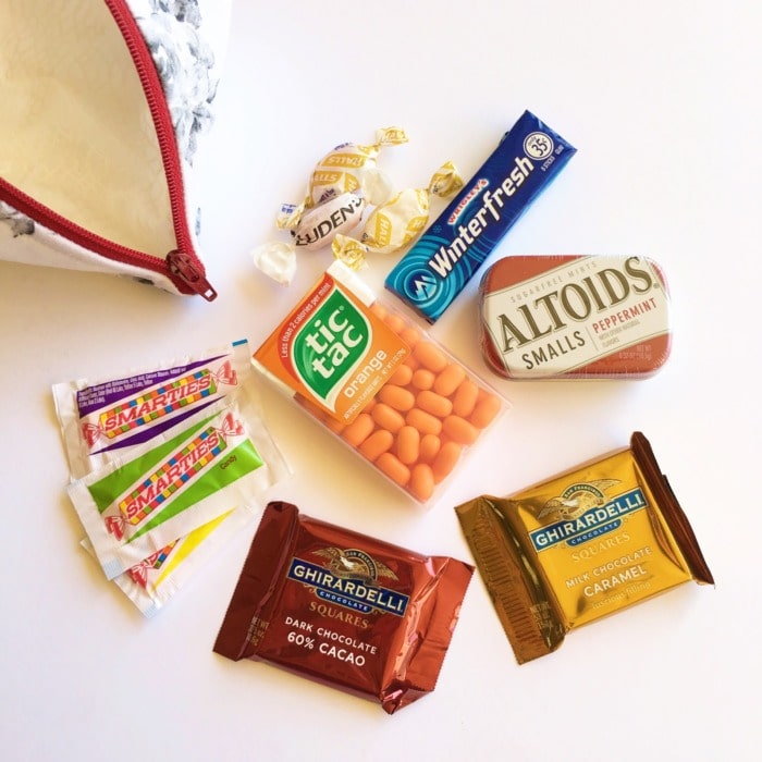 Close up of candy and mints in a zipper pouch.