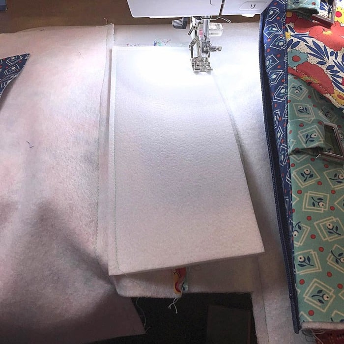 Sewing Tip: Add tape or glue between layers hold bag bottom support in place while sewing.