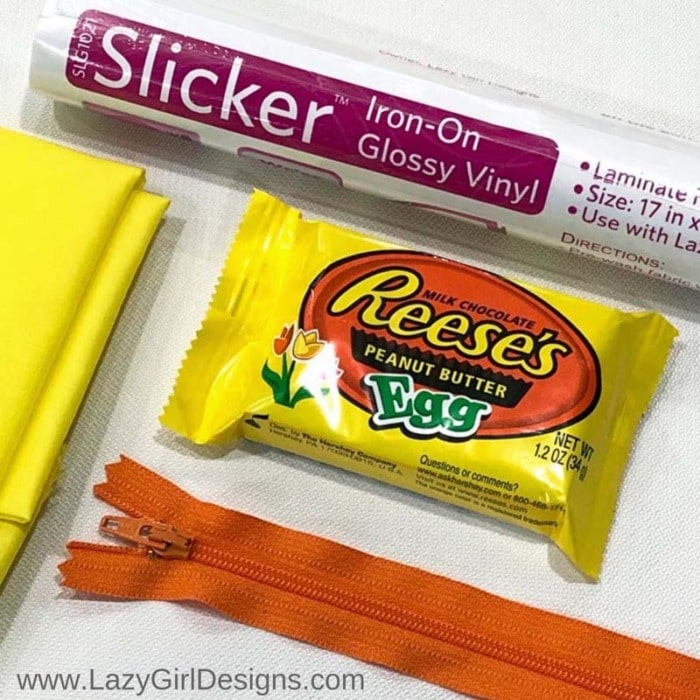 Candy wrapper and sewing supplies, iron-on glossy vinyl, fabric, zipper.