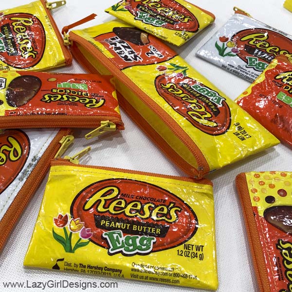 Several small zipper pouches made from candy wrappers.