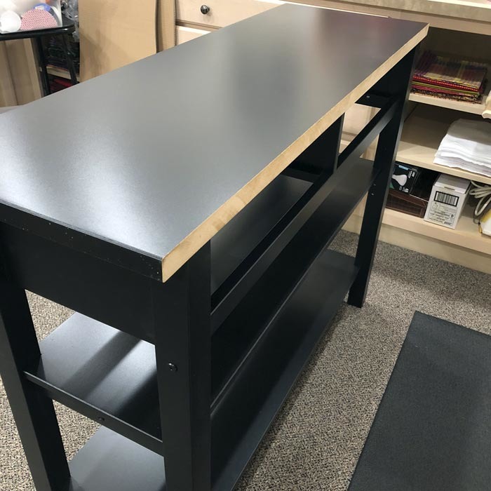 View of trimmed edge of IKEA Norden sideboard top.