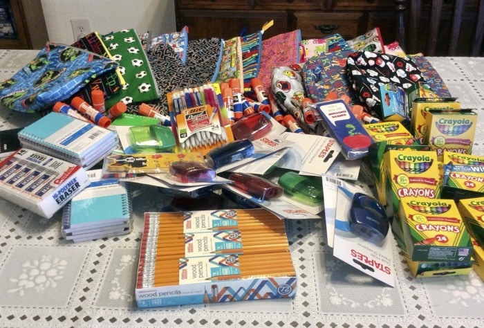 A group of school supplies and small zipepr pouches.