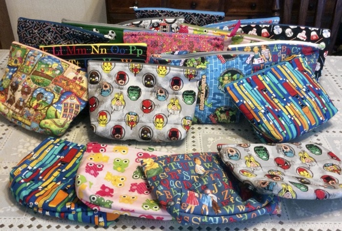 18 small zipper pouches in novelty fabrics.