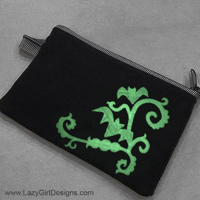 Glow in the dark embroidery thread on a small zipper pouch.