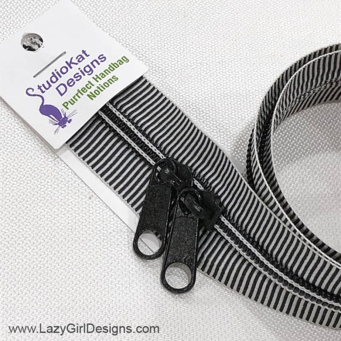 Black and white mini striped zipper with two pulls.