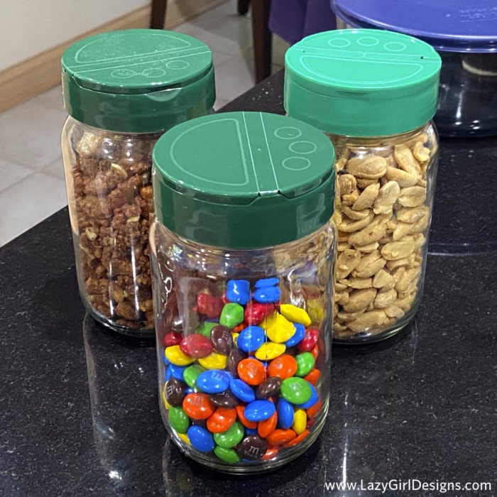 Glass jars filled with peanuts and chocolate