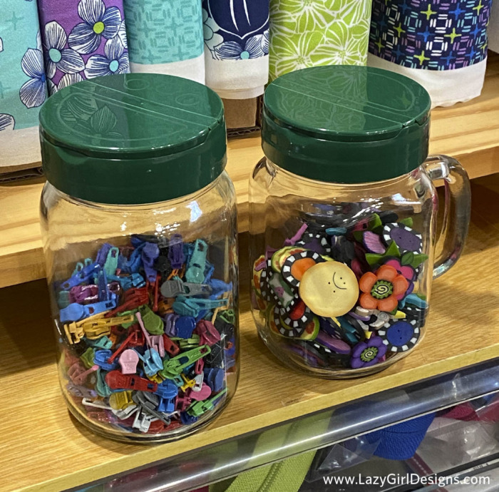 Glass jars filled with sewing supplies as a storage hack